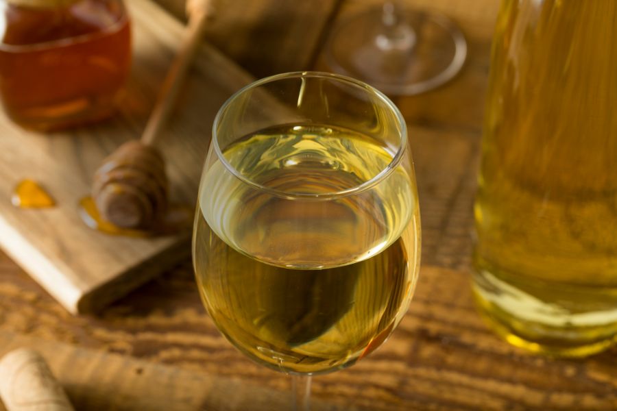 Glass of sweet yellow honey mead